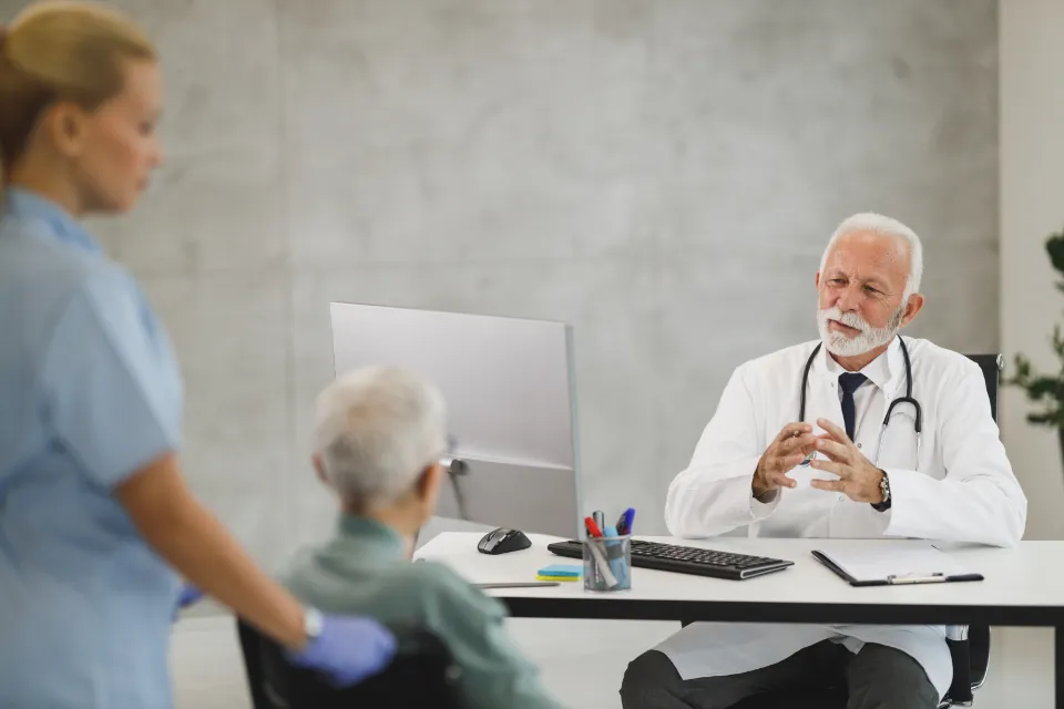 A doctor at his desk in a bright clinic